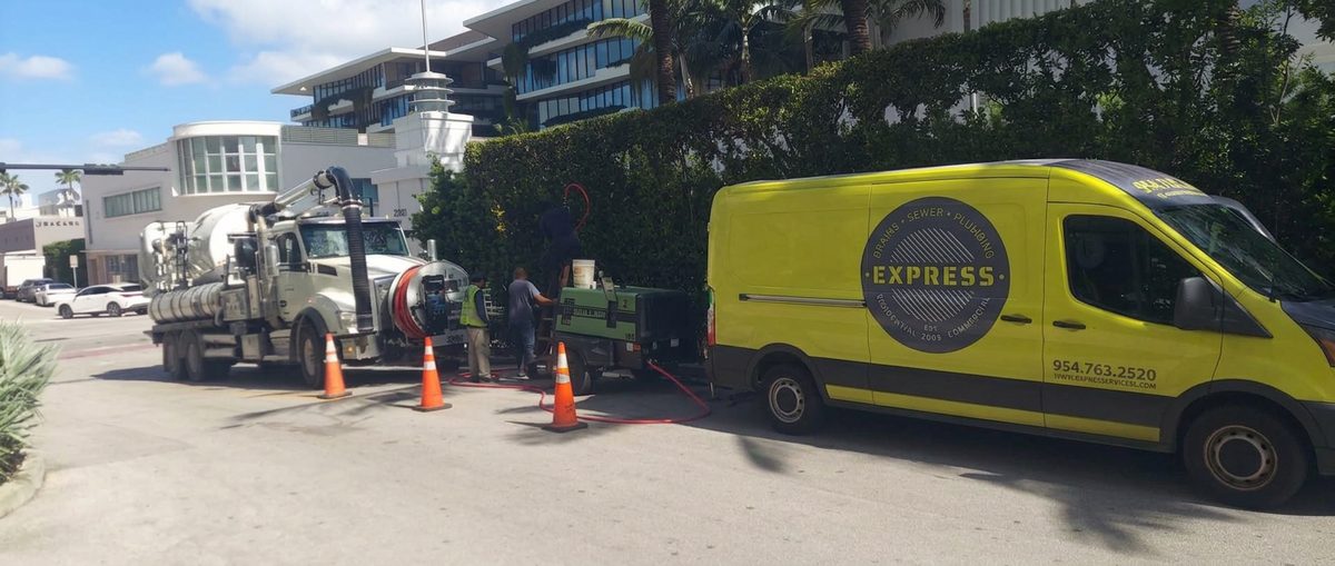 Yellow Express service van with its side door closed beside a work site